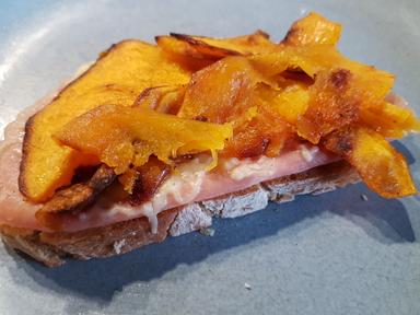 A ham and pumpkin sandwich ready to be eaten.