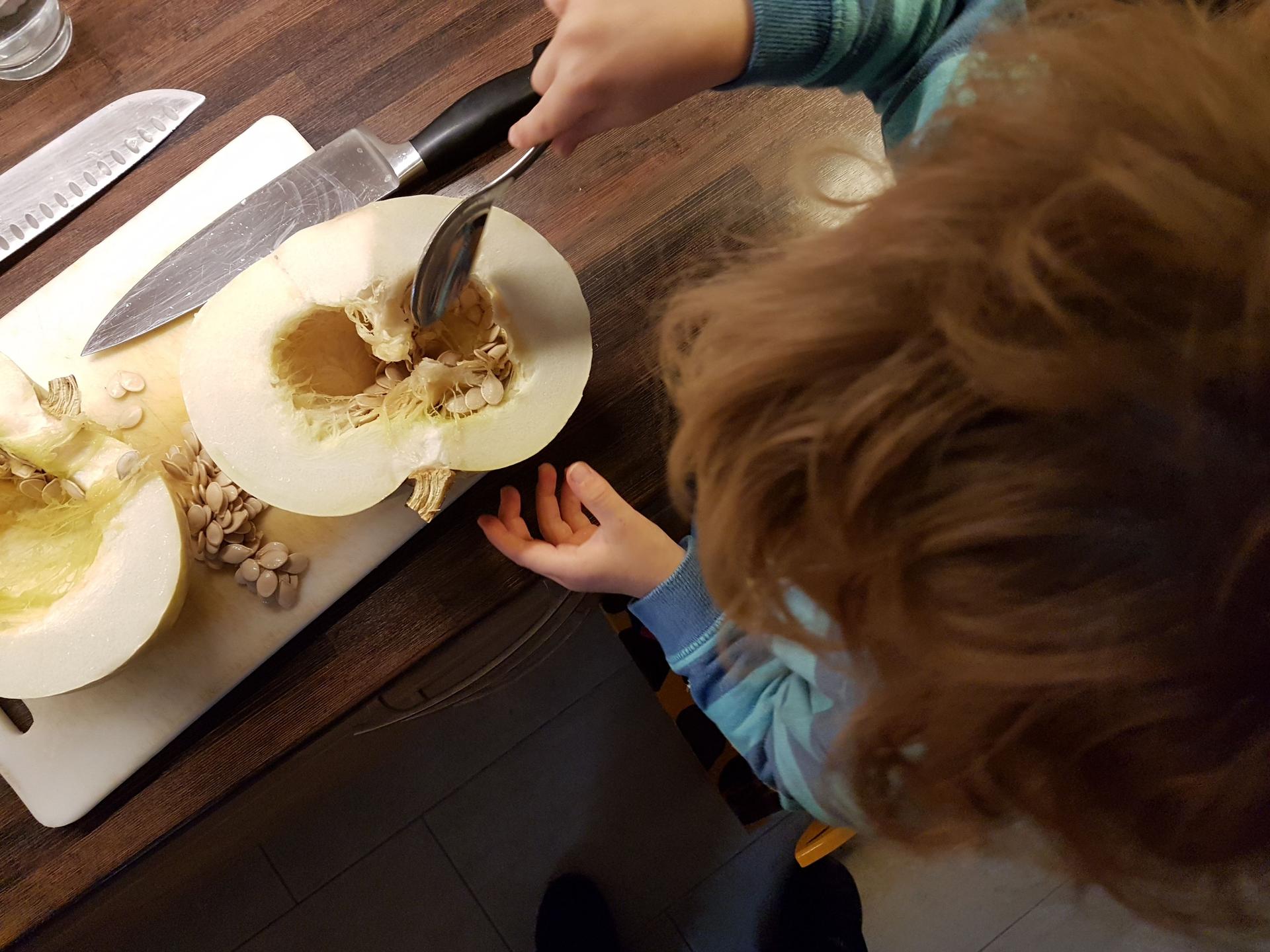 One of my little helpers scraping the seeds from the pumpkin.