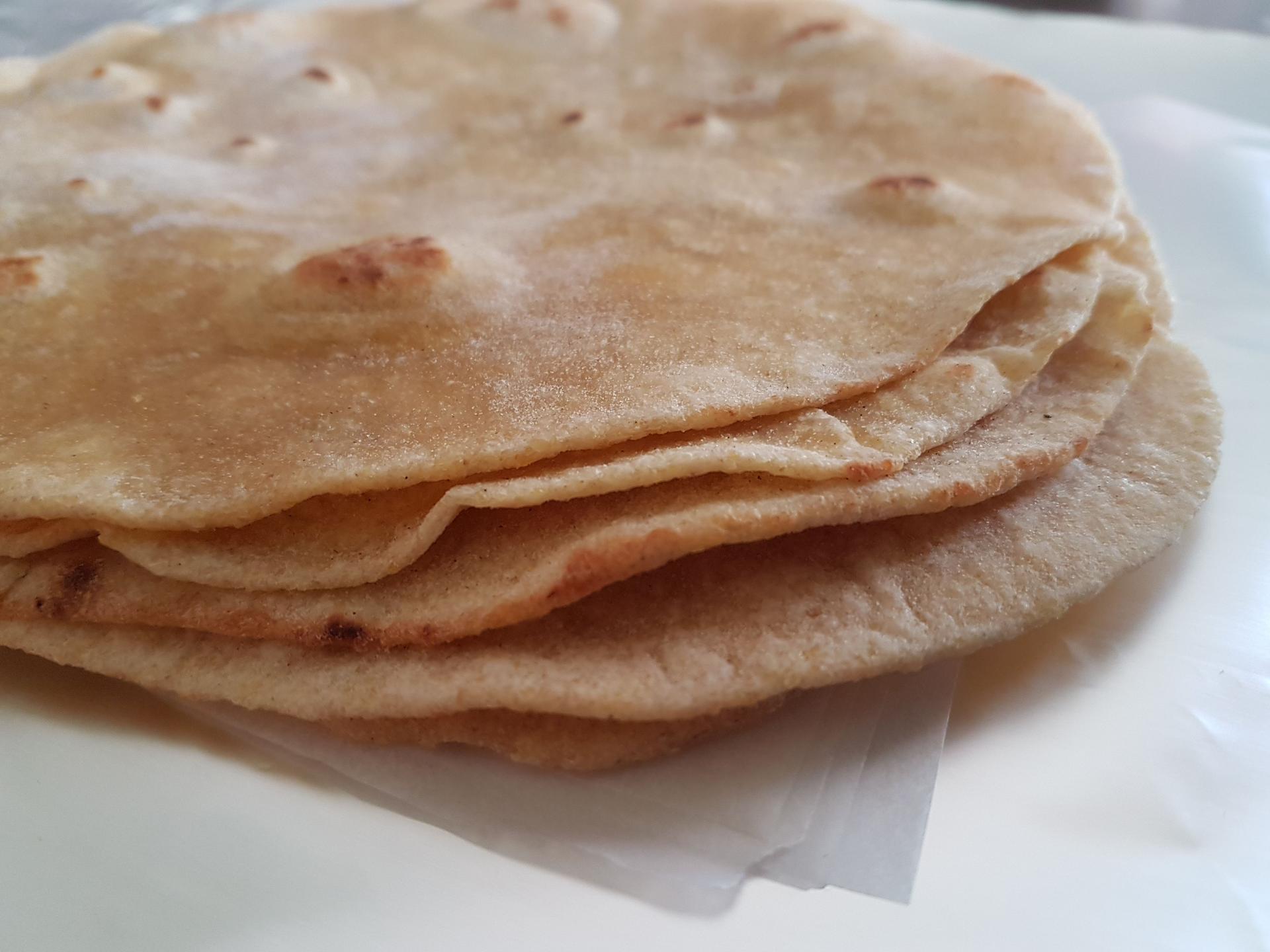 A stack of freshly made corn tortillas.